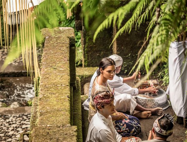 A Group Of People Sitting On A Stone Wall