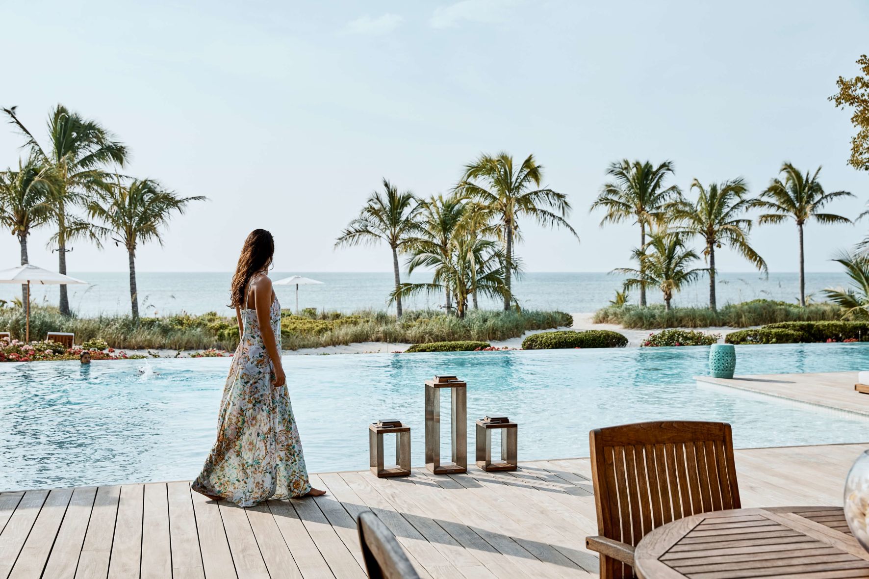 A Person Standing On A Dock Over A Body Of Water