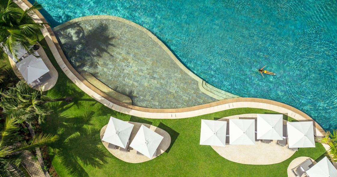 A Group Of White Tents On A Beach