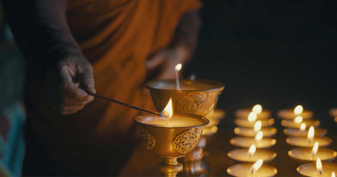 A Person Lighting A Candle