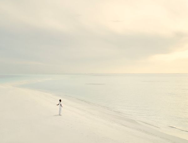 A Person Walking On A Snowy Road