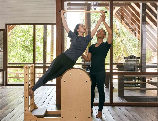 A Couple Of Women Posing For A Picture On A Wood Deck