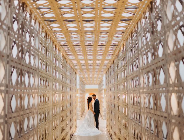 A Man And Woman In A Large Room With Many Rows Of Books