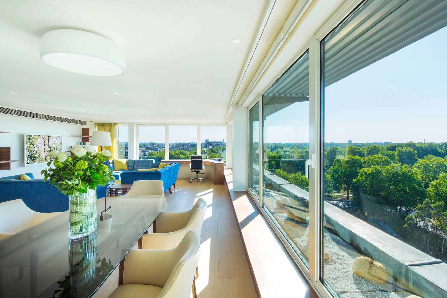 A Living Room With A Large Glass Wall And A Large Window