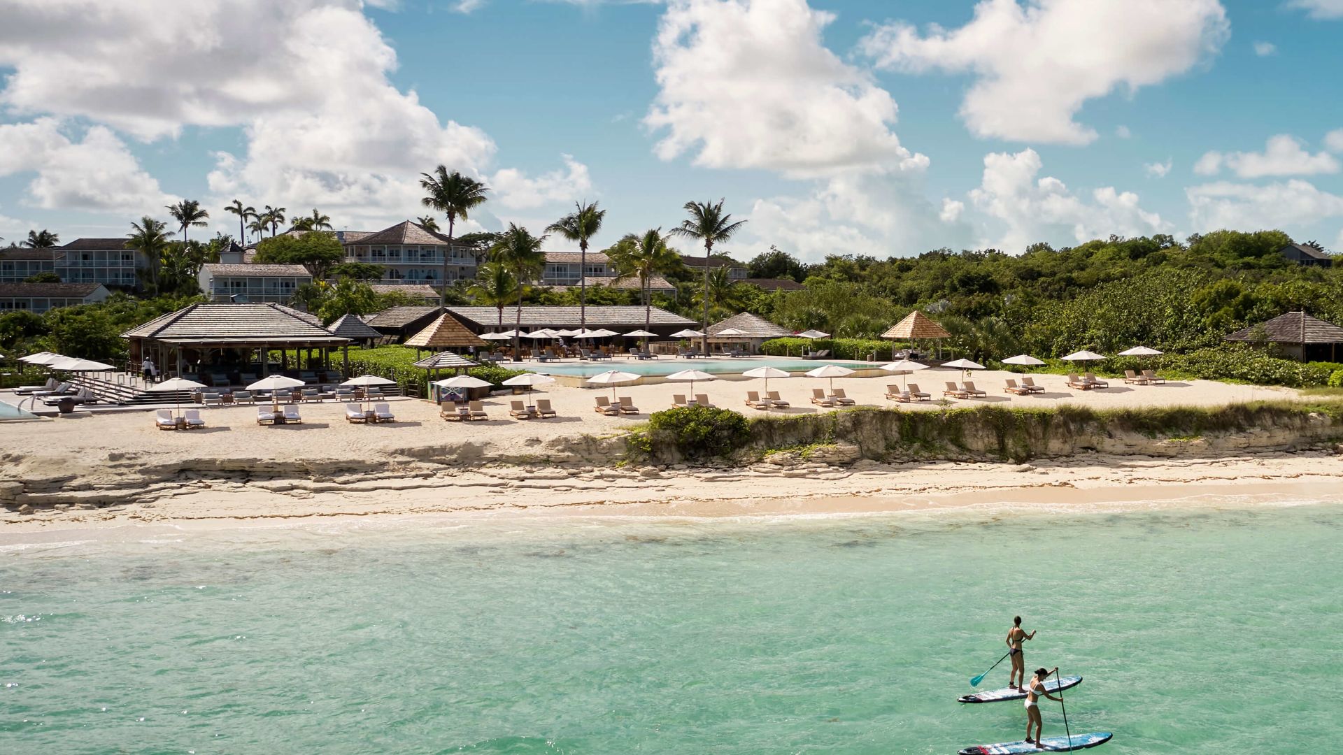 A Couple People On A Small Boat In The Water