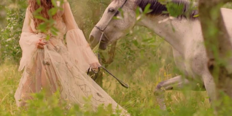 A Person In A Dress Riding A Horse