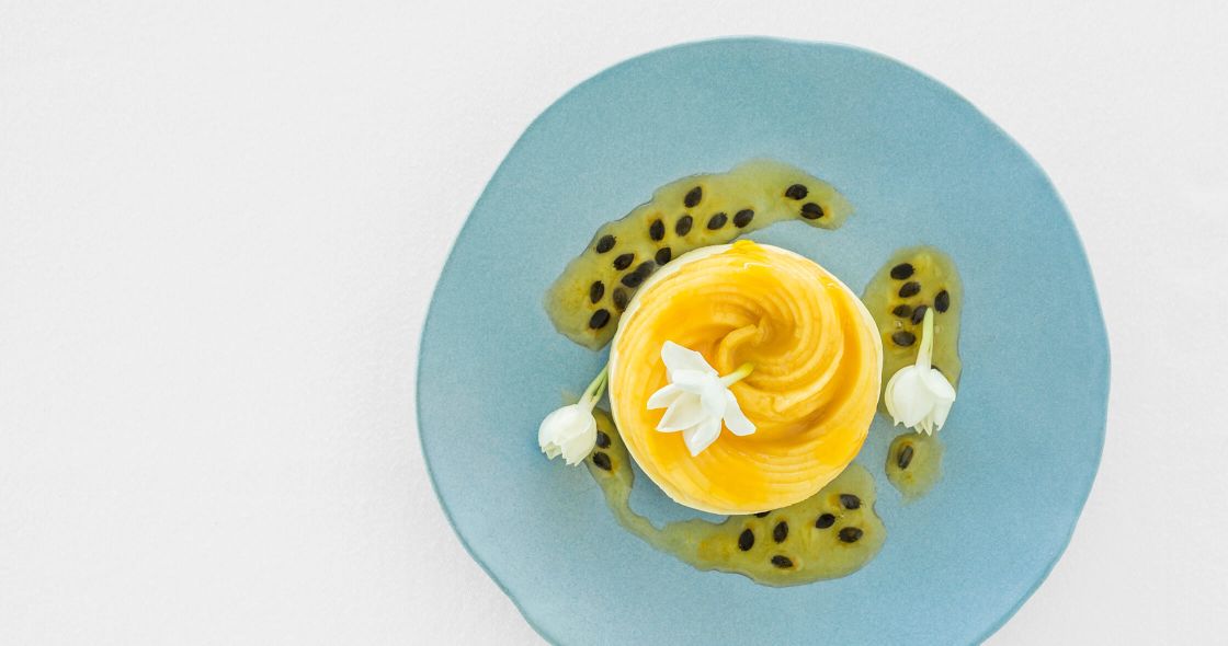A Plate With A Yellow Flower And A White Flower On It