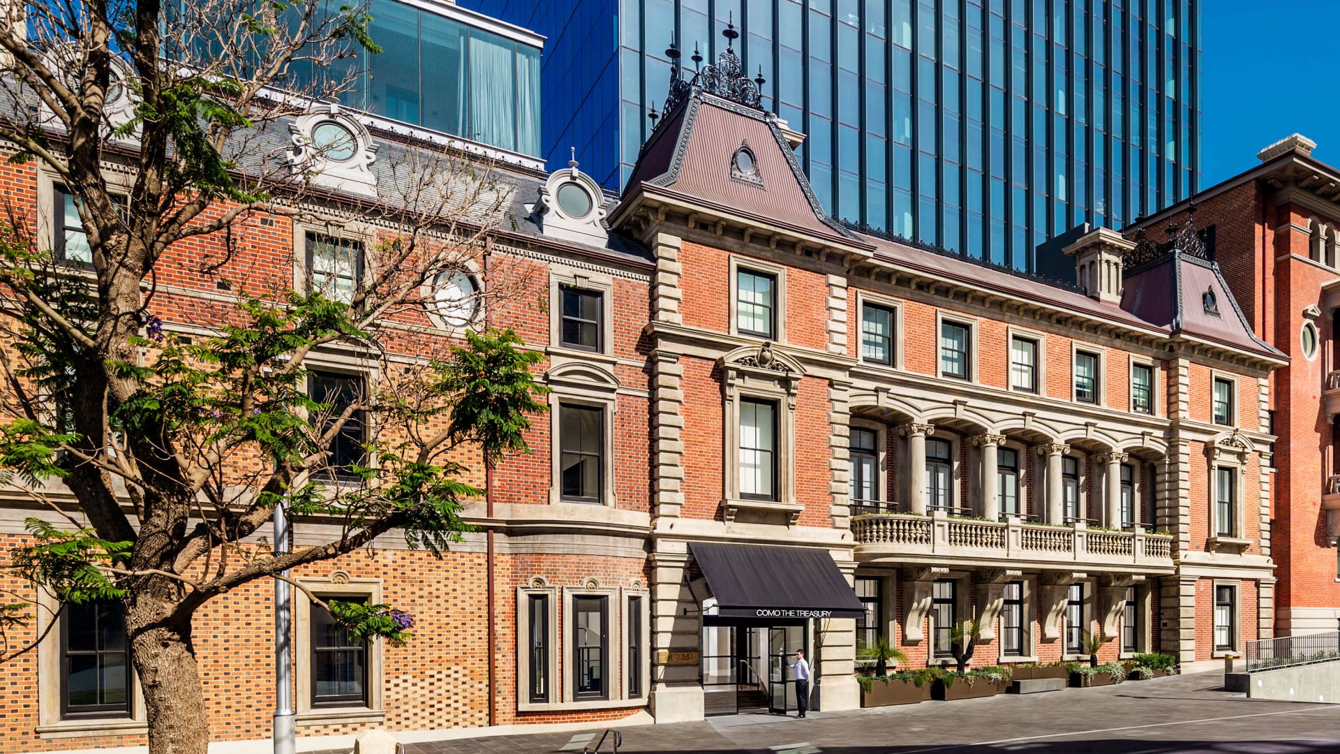 A Building With A Tree In Front