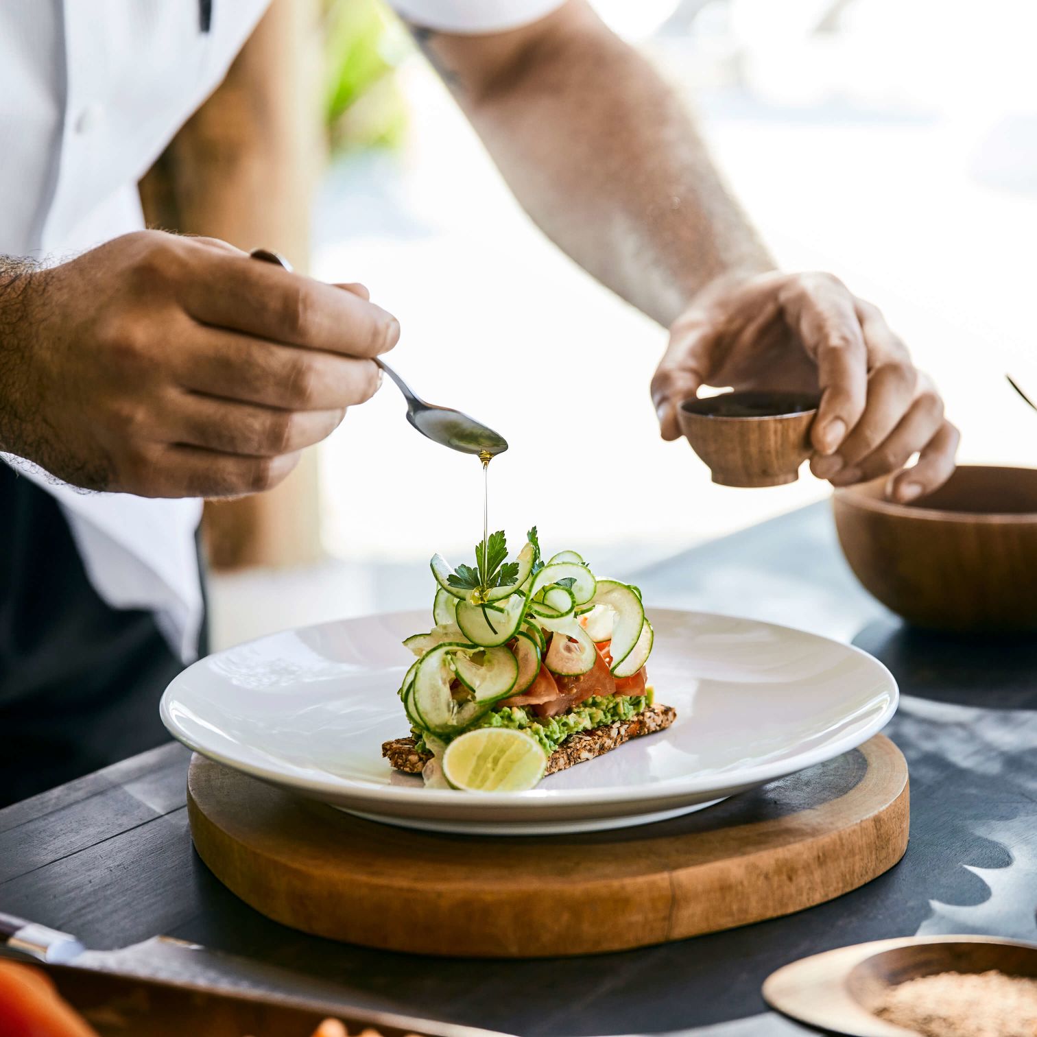 A Man Cutting Food On A Plate