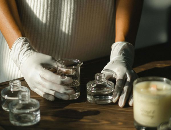 A Person Pouring Liquid Into Glasses