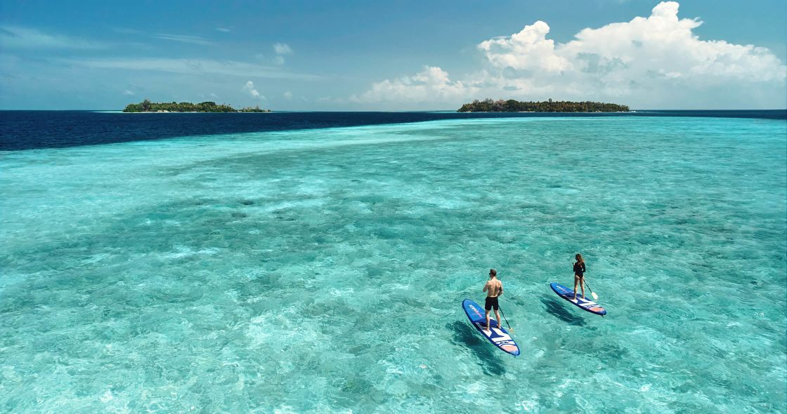 A Group Of People On Surfboards In The Ocean