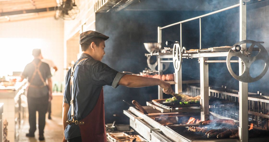 A Person Cooking Food In A Large Kitchen
