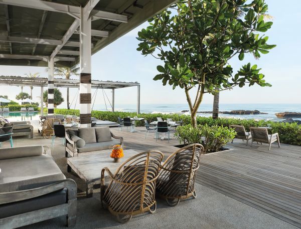 A Patio With Chairs And A Tree