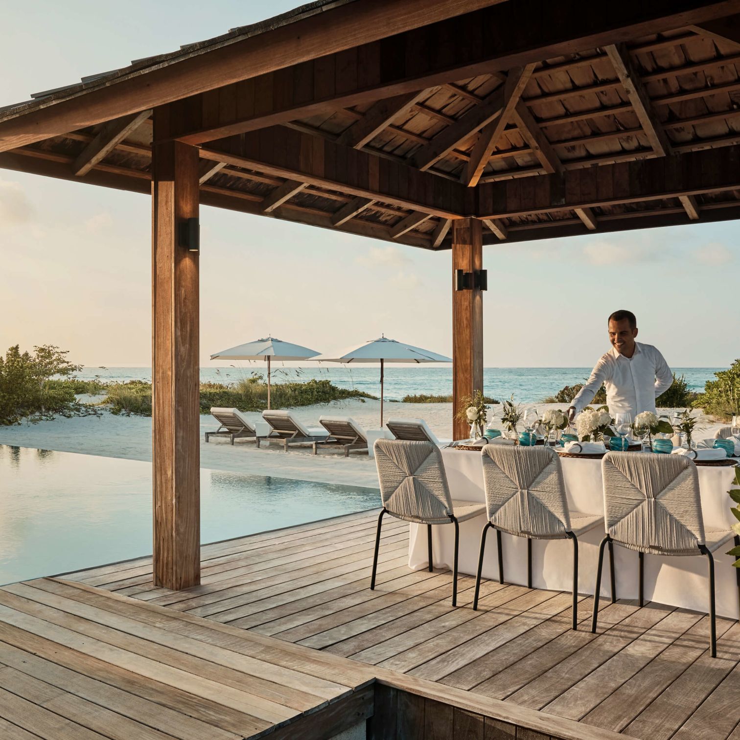 A Person Standing Next To A Pool