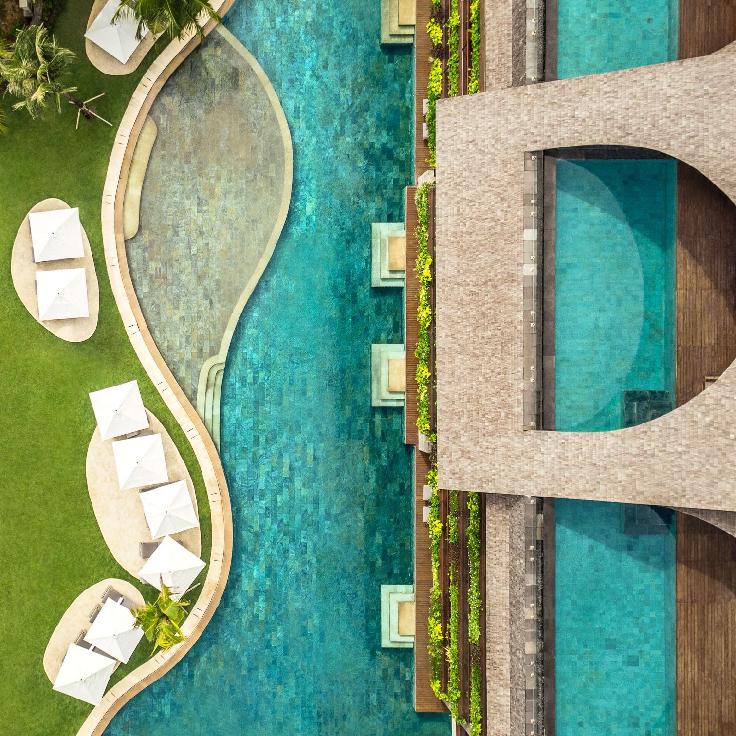 A Green And White Building With A Green Wall And A Tree
