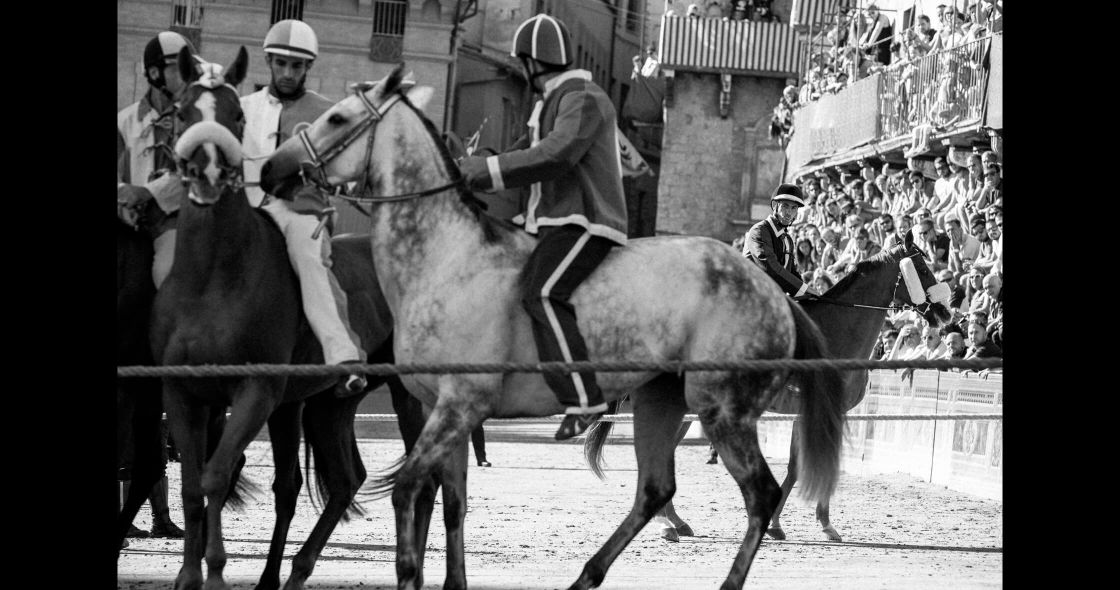 A Group Of Men Riding Horses