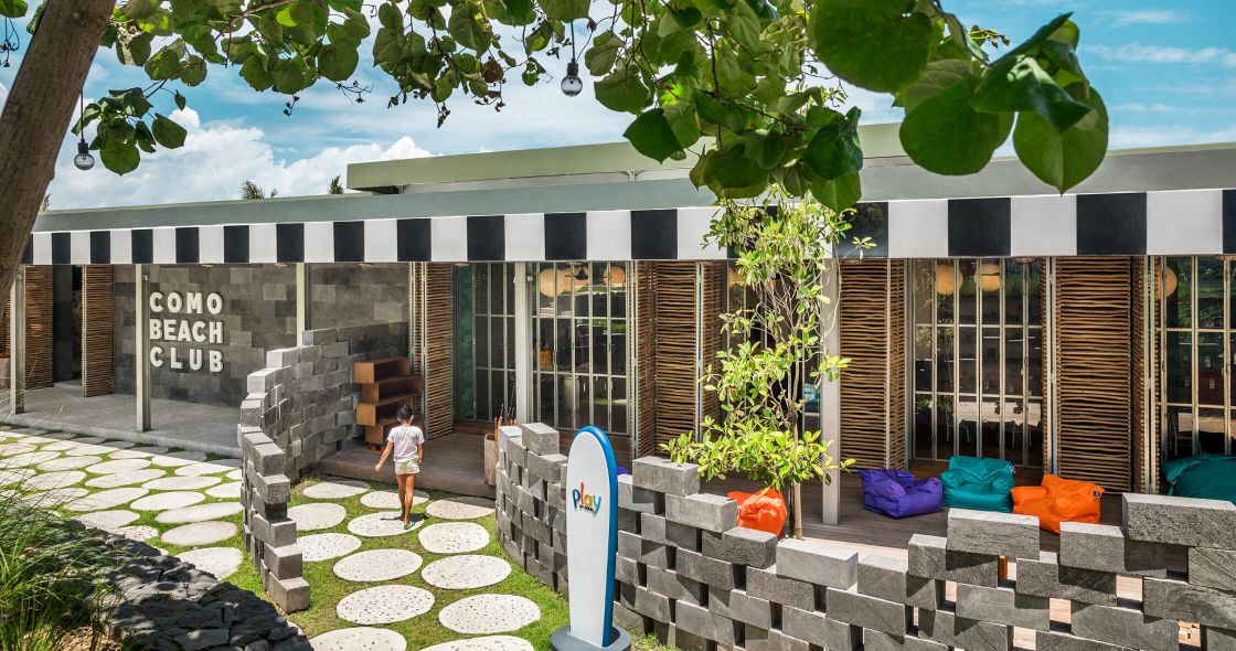 A Person Walking Outside Of A Building