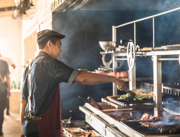 A Person Cooking Food In A Large Kitchen