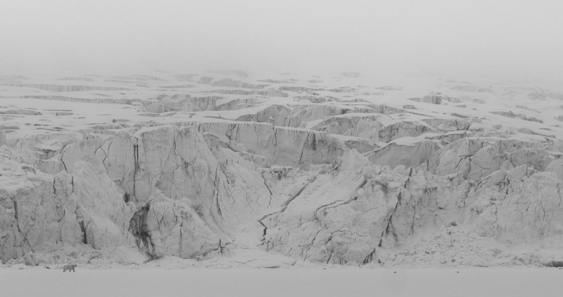 A Snowy Landscape With A Large Rock Formation