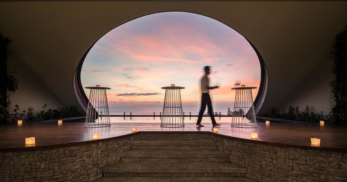 A Person Standing On A Set Of Stairs With A Large Red Circle In The Background