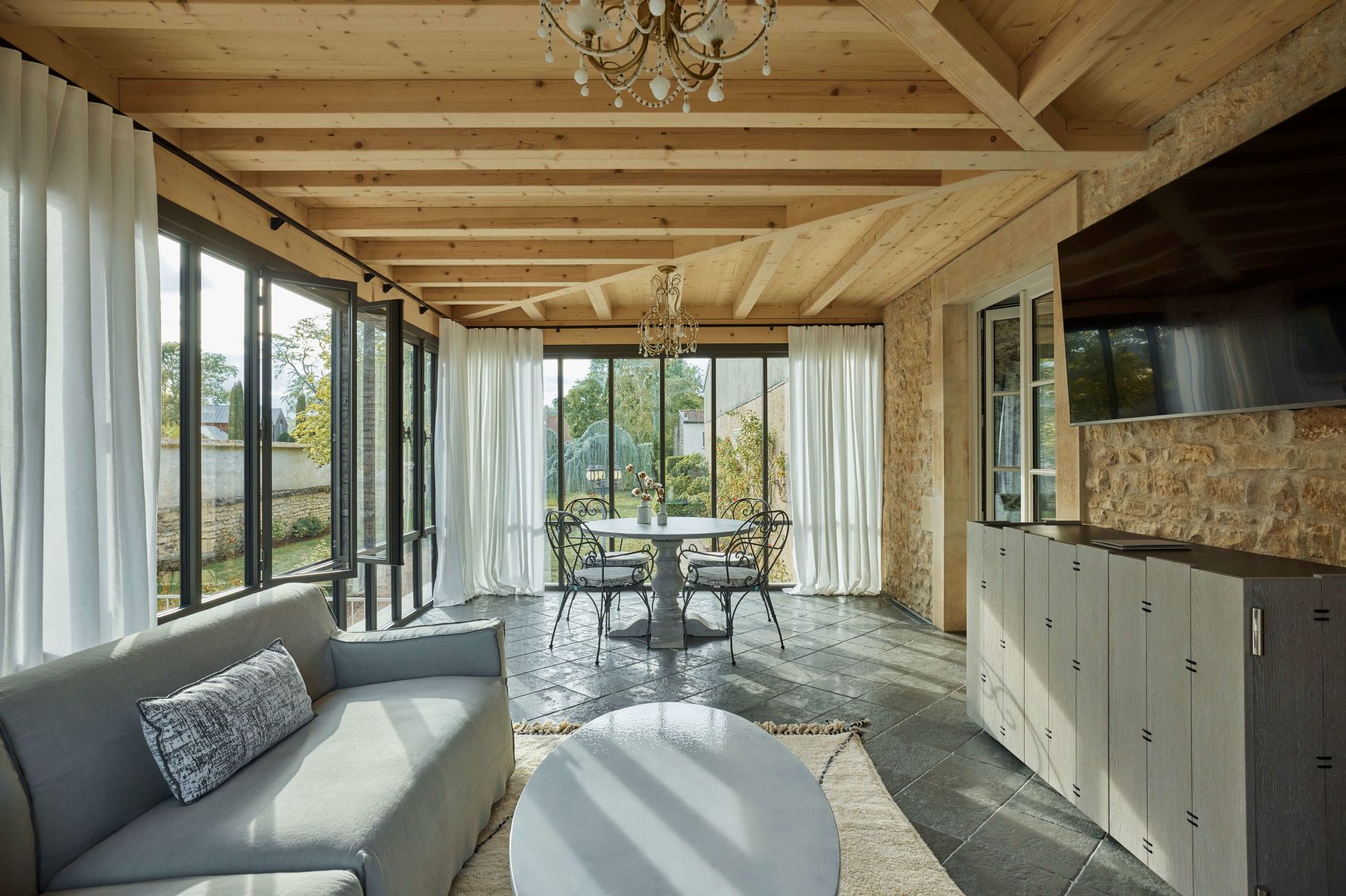 A Living Room With A Table And Chairs