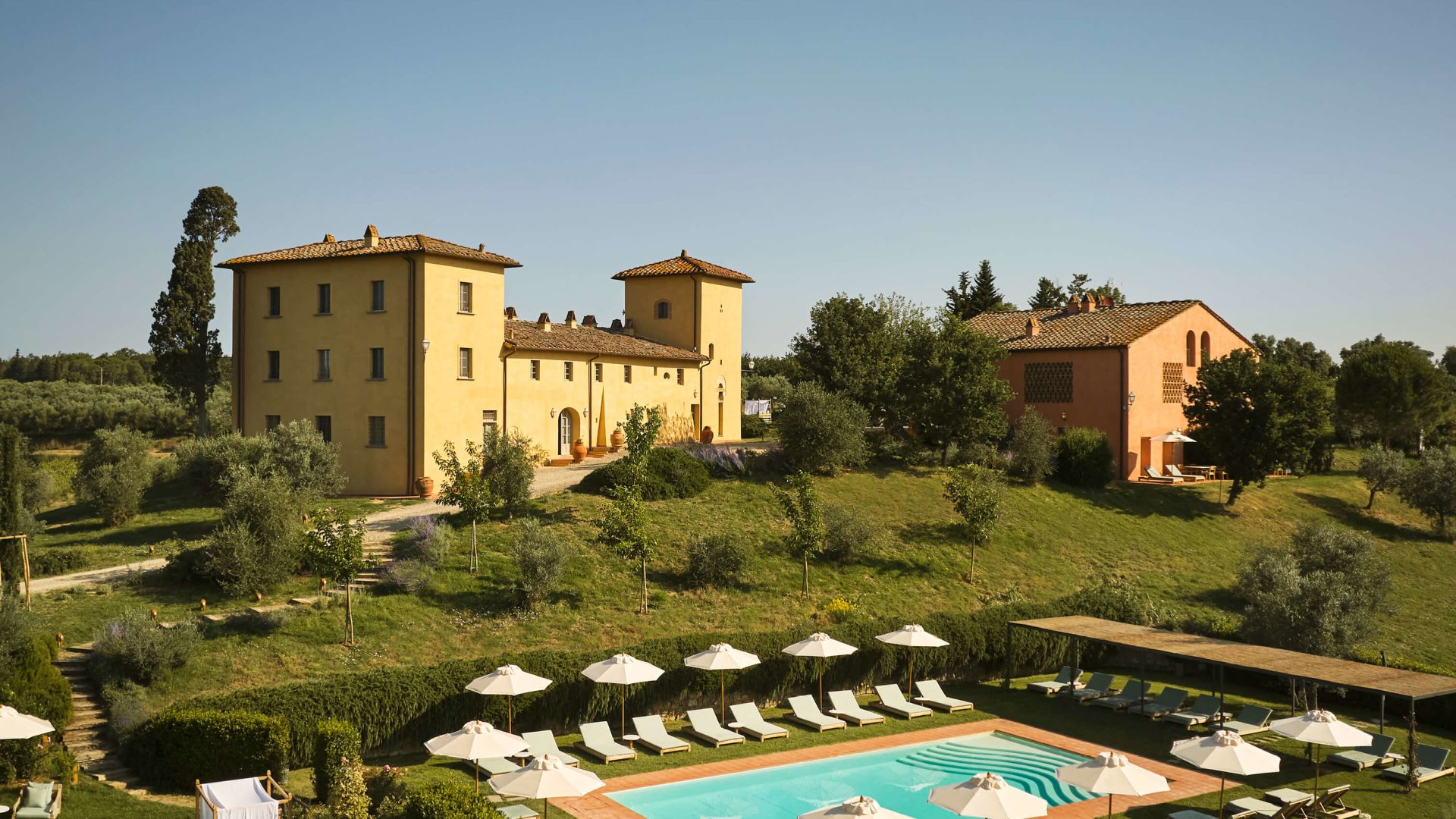 A Large Building With A Pool In Front Of It