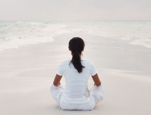 A Person Sitting On A Beach